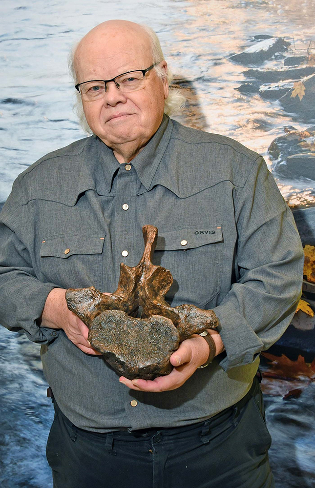 Dave Lieberth holding a prehistoric vertebra