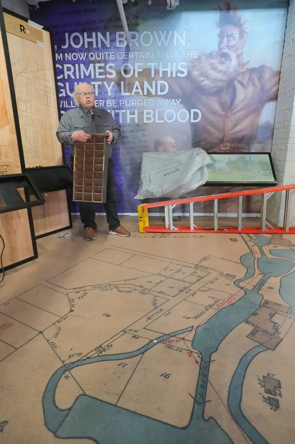 Local historian Dave Lieberth, a driving force of the Akron History Center, leads a tour of the downtown museum, which is still under construction on South Main Street near the Akron Civic Theatre. The floor features an 1899 city map that shows the Ohio & Erie Canal. PHIL MASTURZO, AKRON BEACON JOURNAL