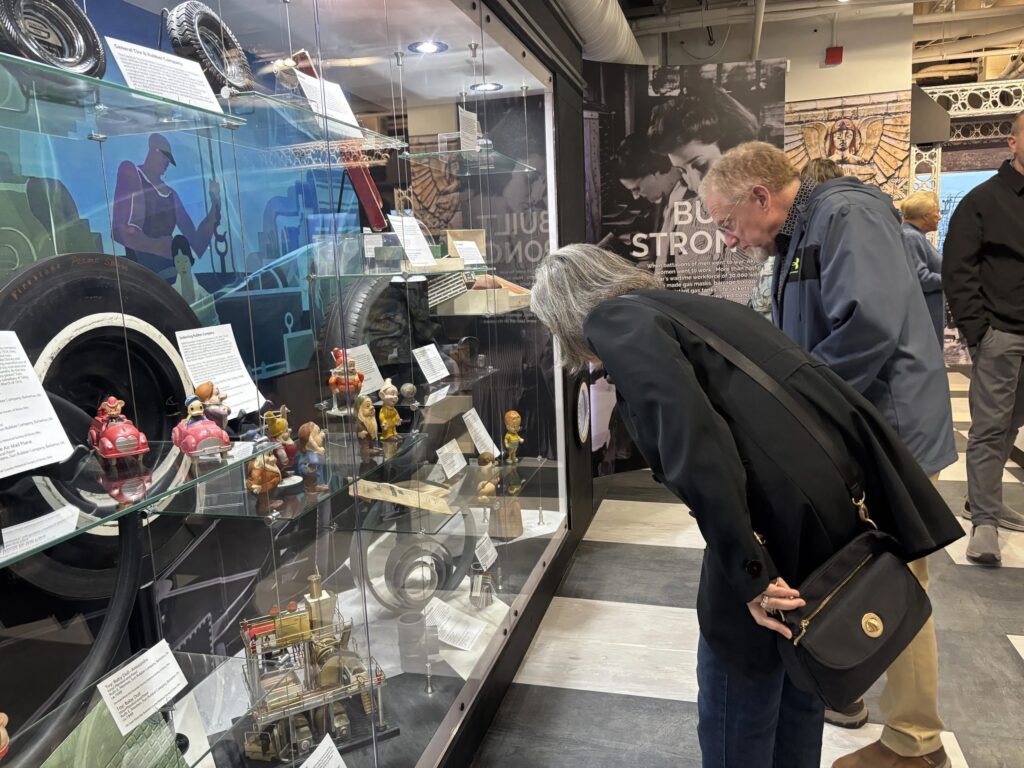 Visitors at the Akron History Center on Saturday, April 5, 2025, examine artifacts on the museum's opening day. The history center houses more than 60 exhibits and 150 artifacts. (Kevin Dilley / Signal Akron)